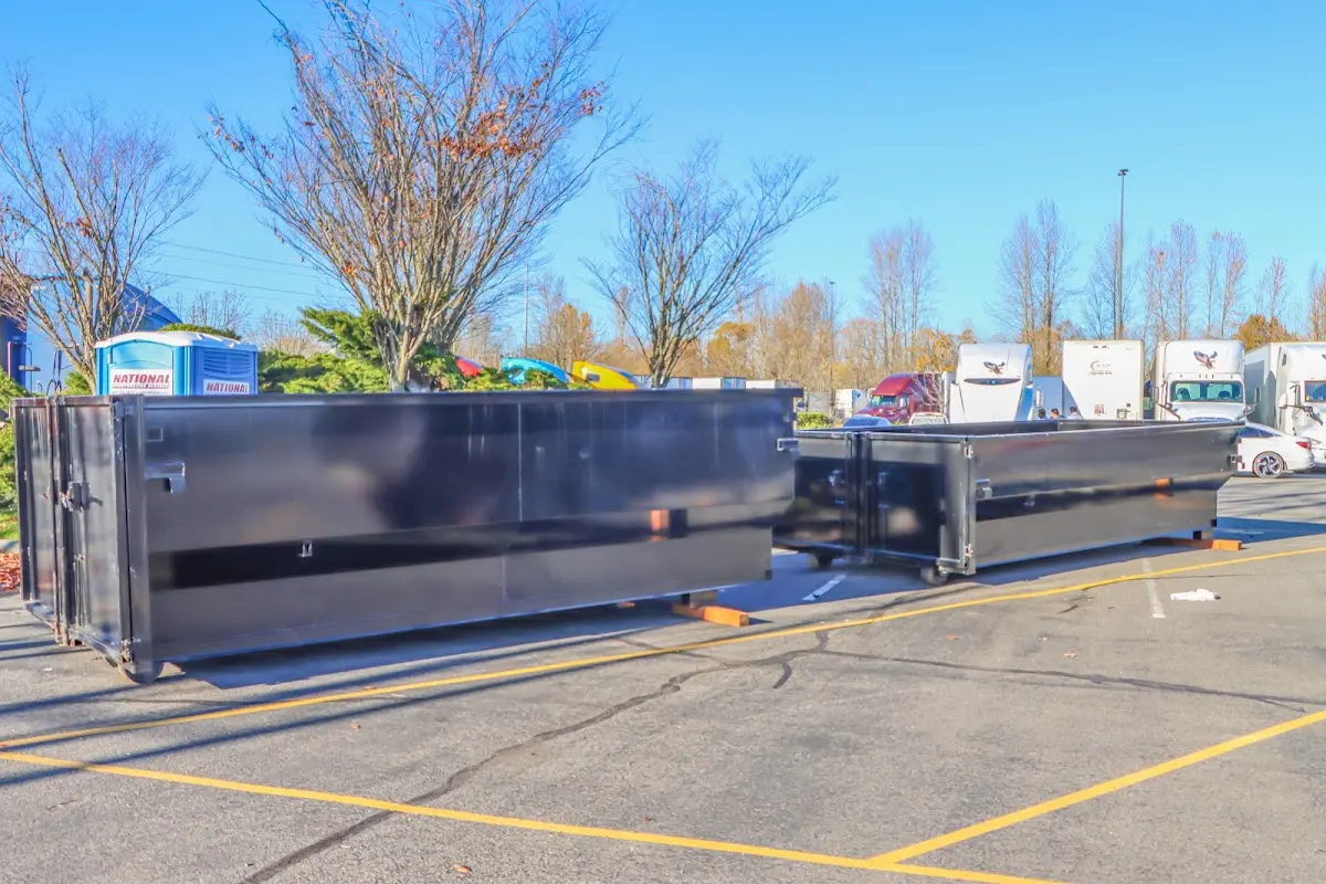 Professional dumpster rental service with roll-off container on residential driveway in London